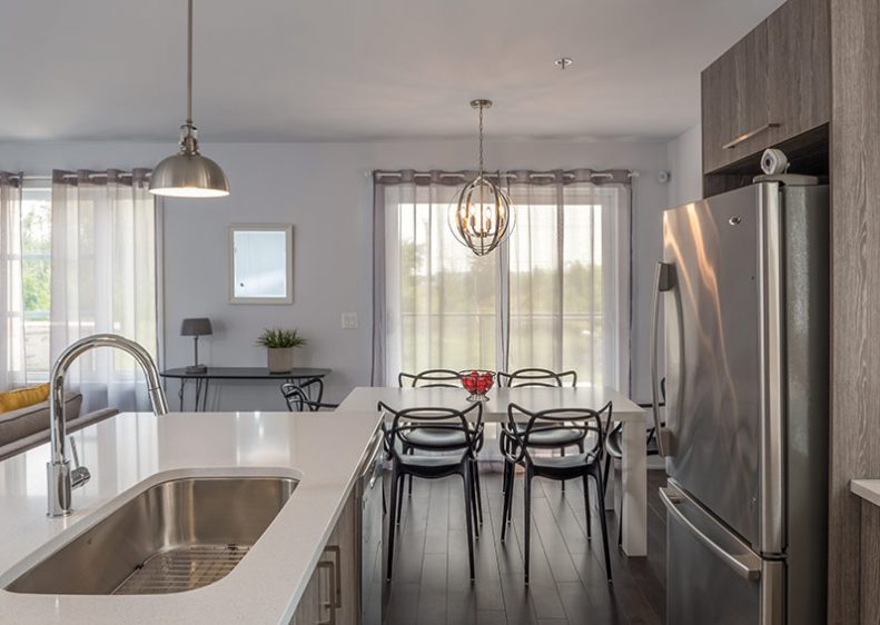 Kitchen and dining room of the model condo at Le Haut Corbusier Laval